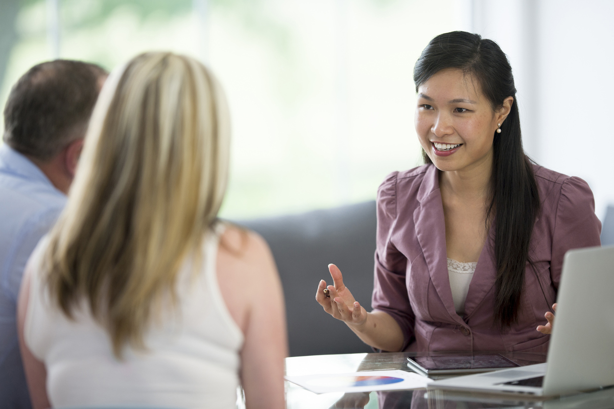 Financial advisor sitting with clients