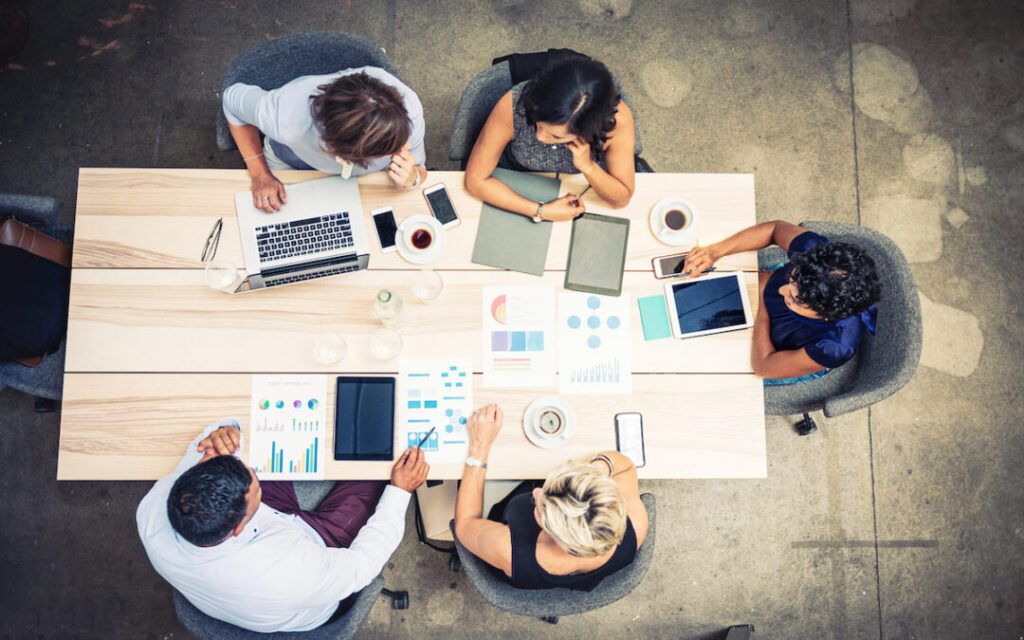 Executives sitting around a table looking at reports