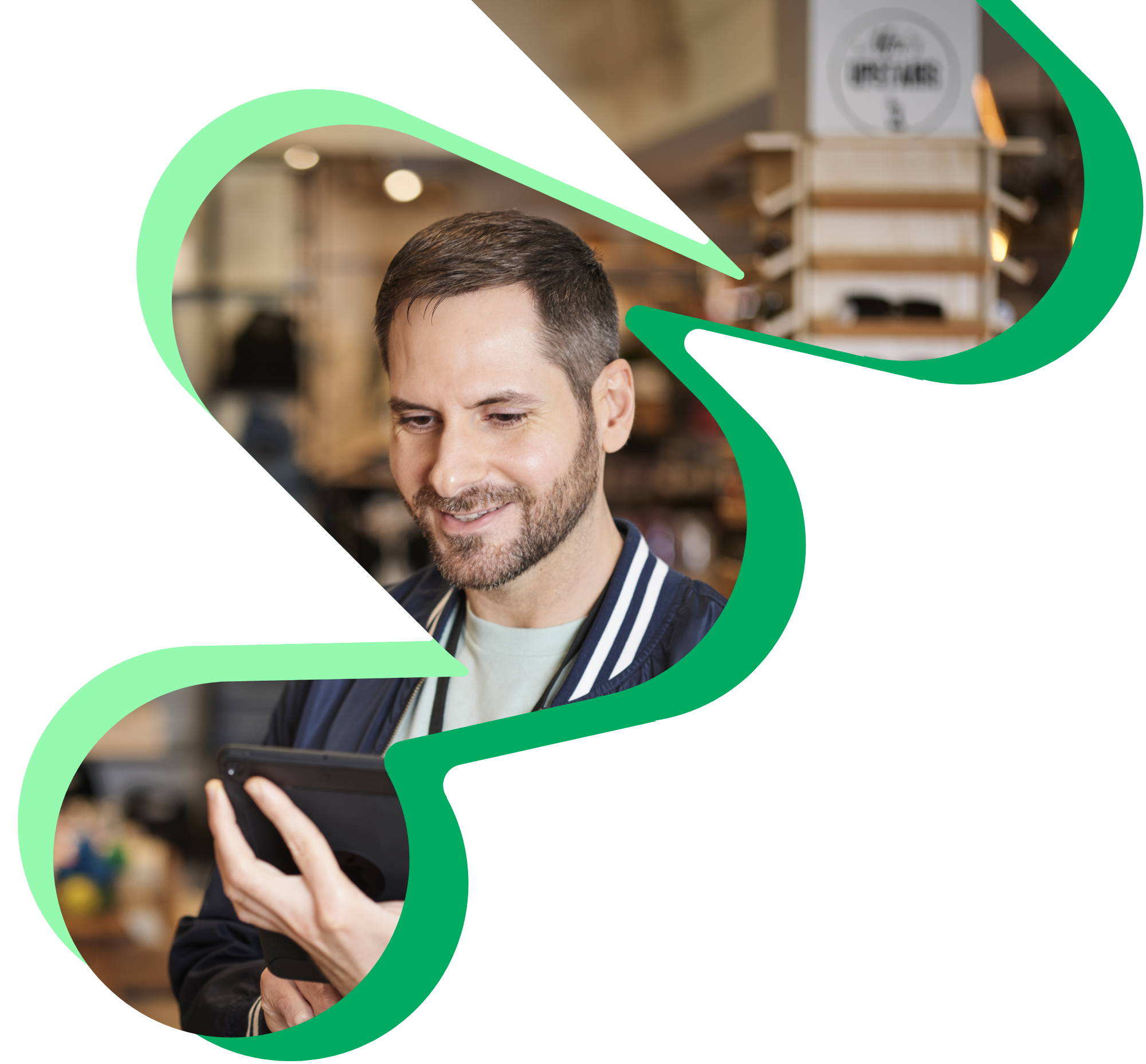 Retail associate looking down at his tablet.