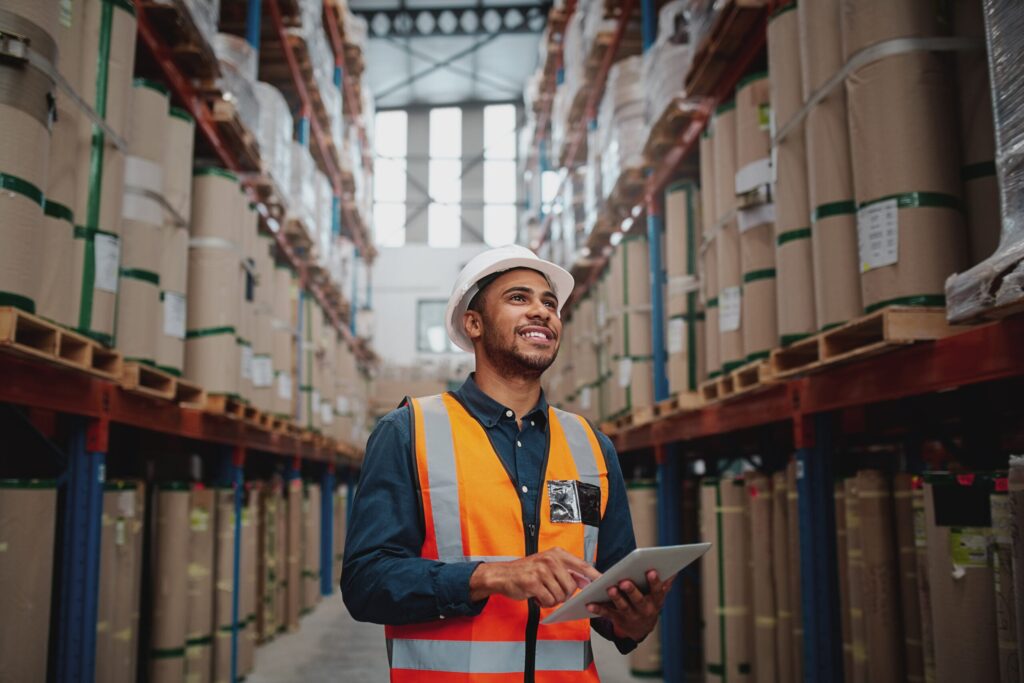 Distribution and logistics worker smiling in warehouse
