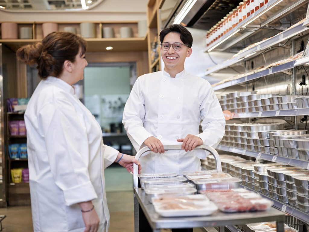 2 supermarket employees talking and smiling
