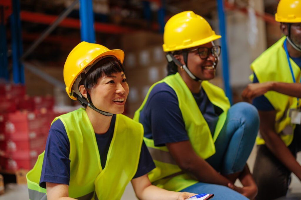 Warehouse Workers Attending A Meeting In A Storage Room
